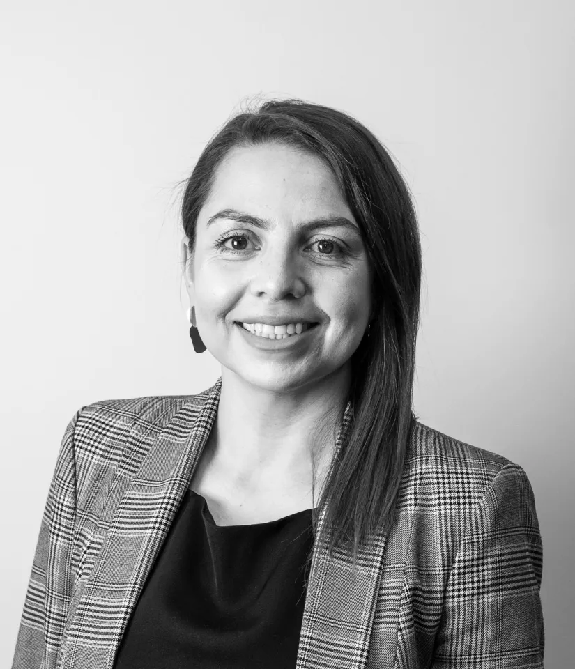 Photo of Natalia Zambrano standing in front of a white wall.